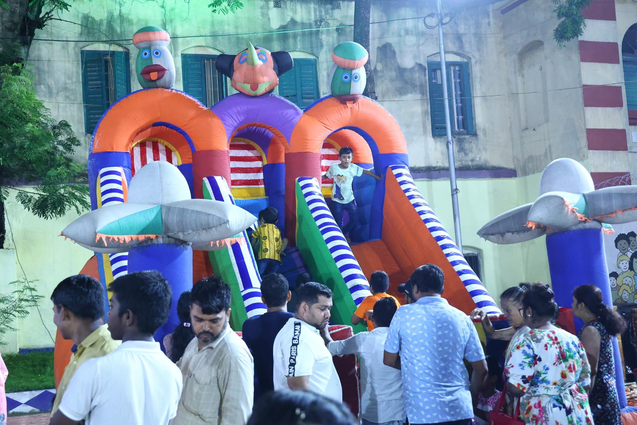 Colourful inflatable bouncy castle with children at the community festival