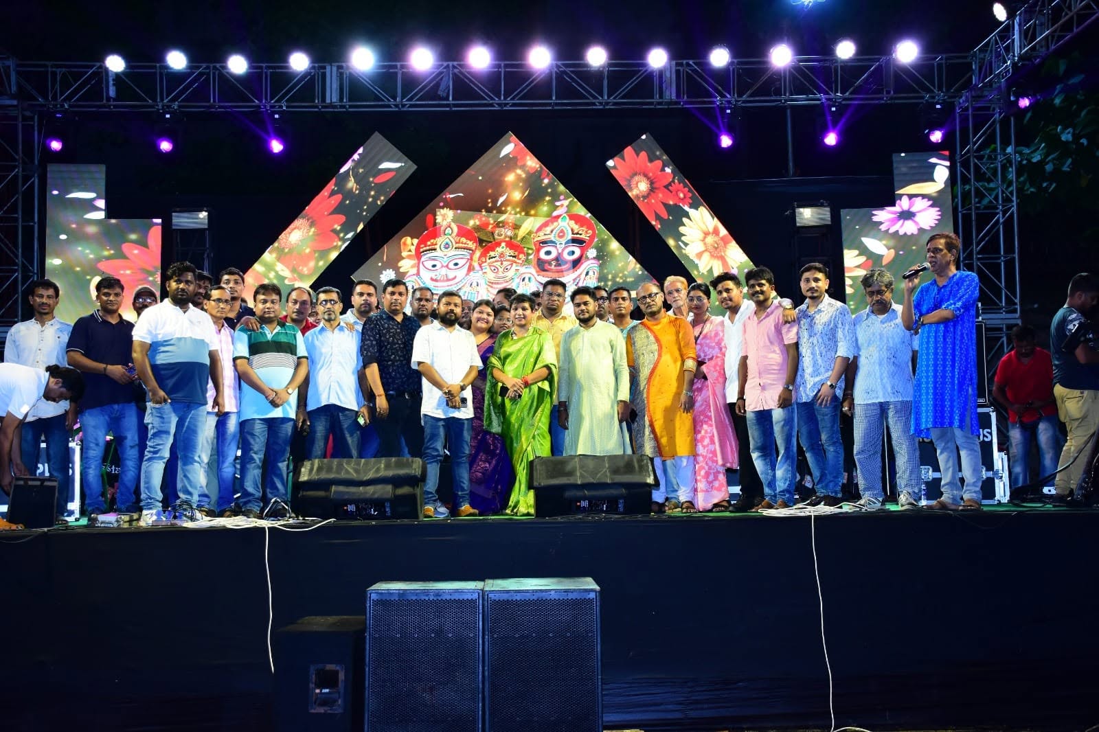 Committee members and guests gathered on the LED stage during a cultural programme